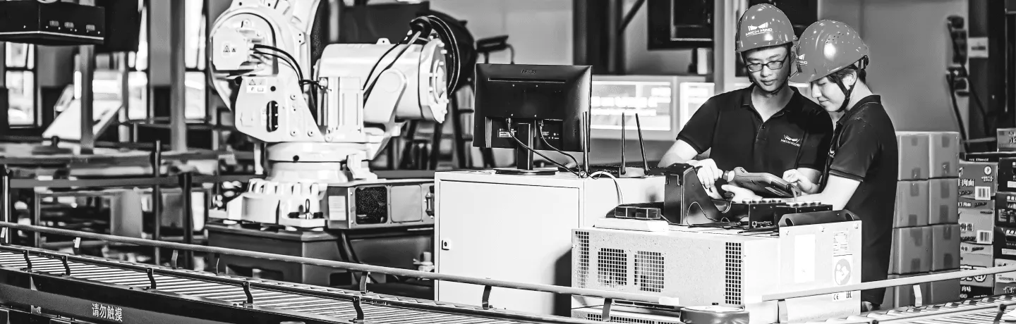 Two workers using AI-powered quality control for smart manufacturing